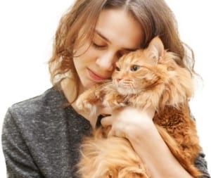 Woman cuddling her older cat.