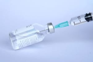 Drawing up a vaccine into a syringe.